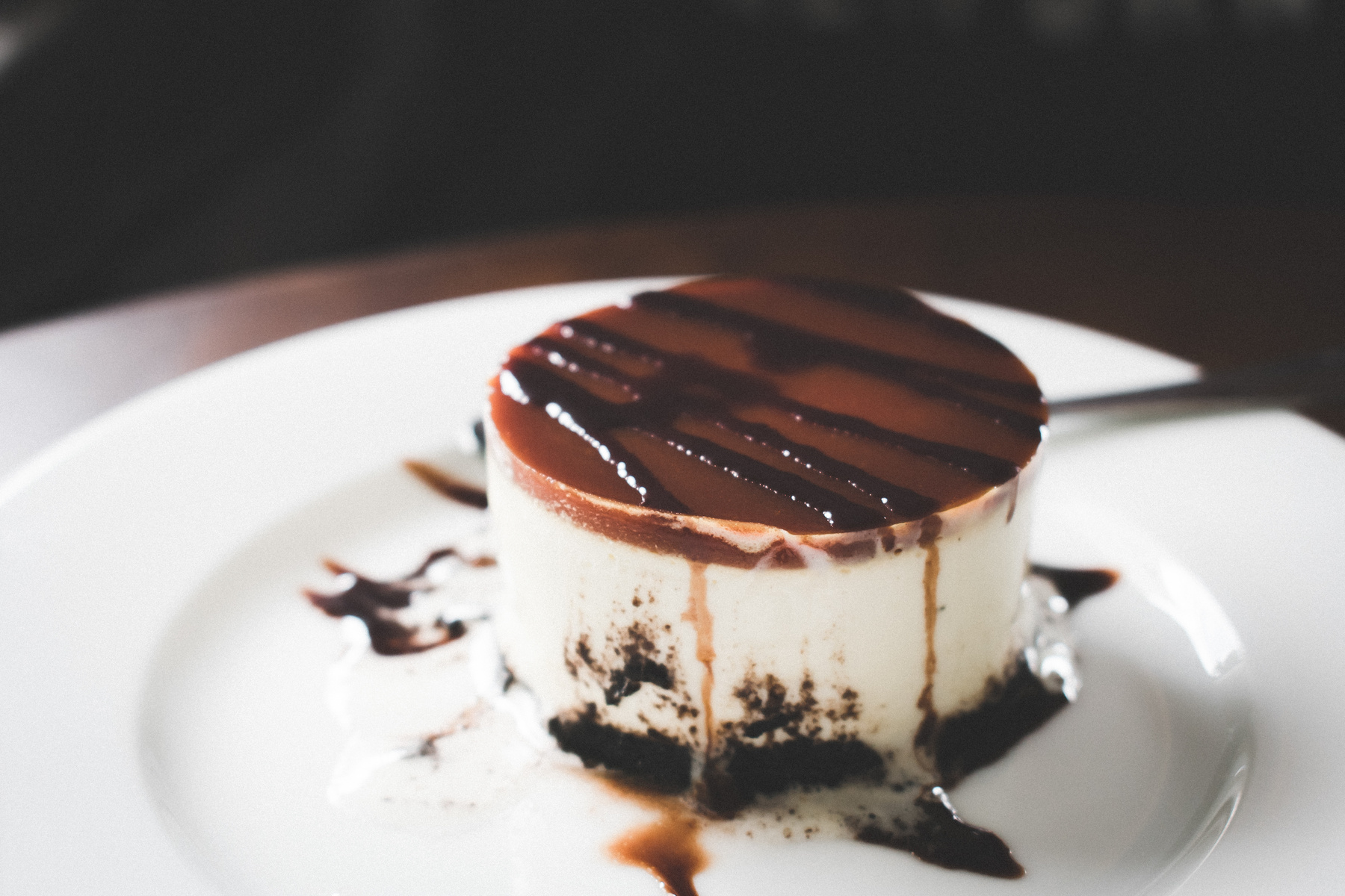 Black, Brown, and White Melted Cake on Round White Ceramic Plate